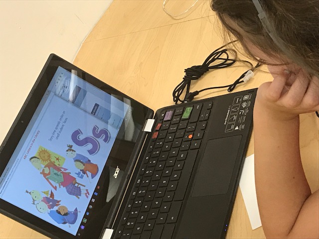 WPS student looking at story on computer