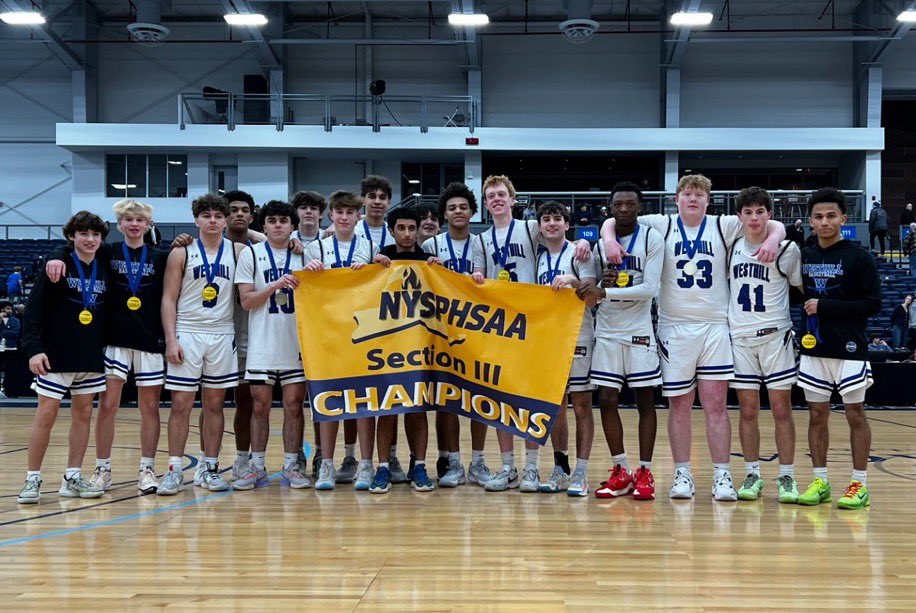 Westhill Boys Basketball Team holding up sectional title banner